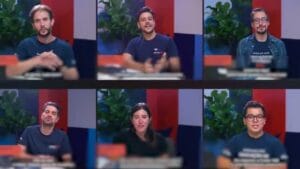 Seis pessoas em um estúdio, sorrindo e discutindo, com plantas ao fundo e um ambiente colorido.